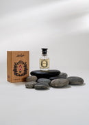 Bottle of perfume, box, and stones on a white background