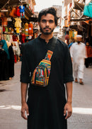 Man wearing a colorful bag in a market setting